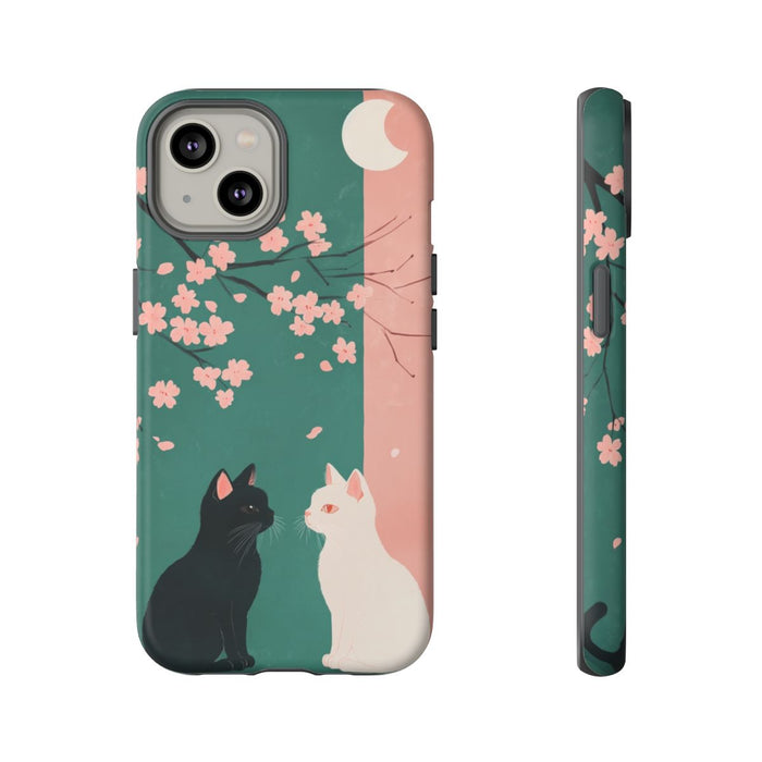 Zwarte en witte katten met sakurabloesem