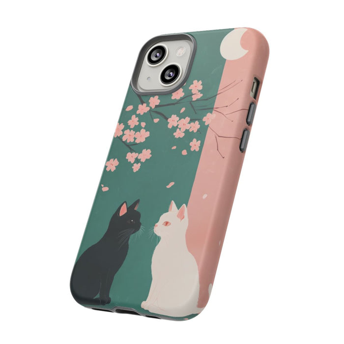 Zwarte en witte katten met sakurabloesem